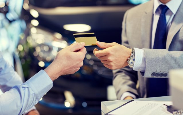 man in suit handing out credit card credit card processing